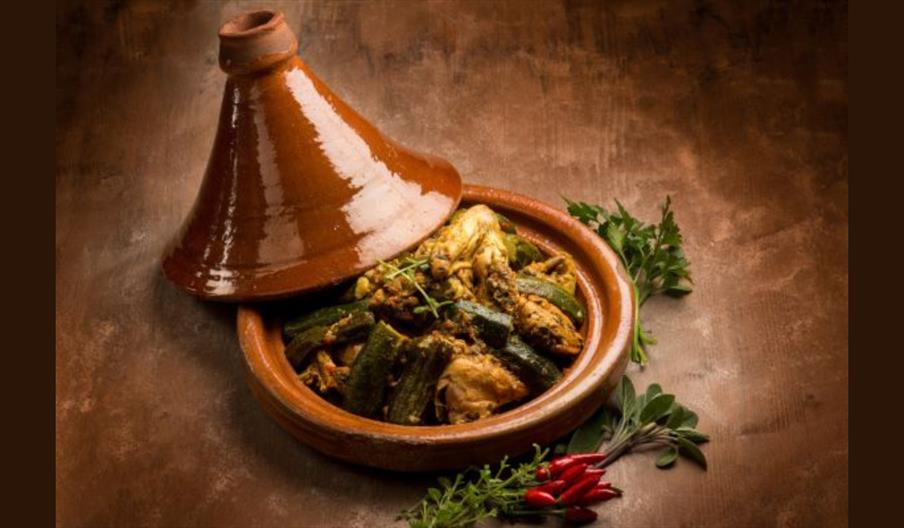 Tagine-style chicken and vegetables in a clay pot