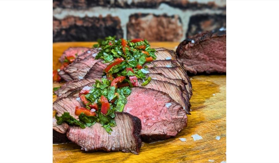 Perfectly cooked steak topped with fresh herbs.