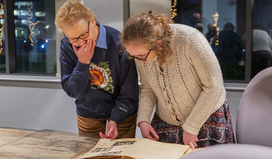 Man and woman reading a book