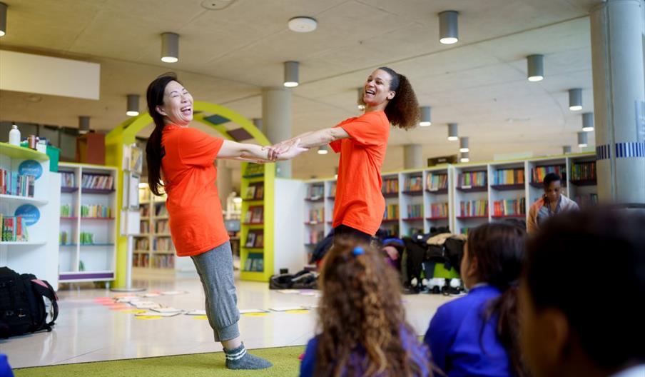 Circus performers in a library setting