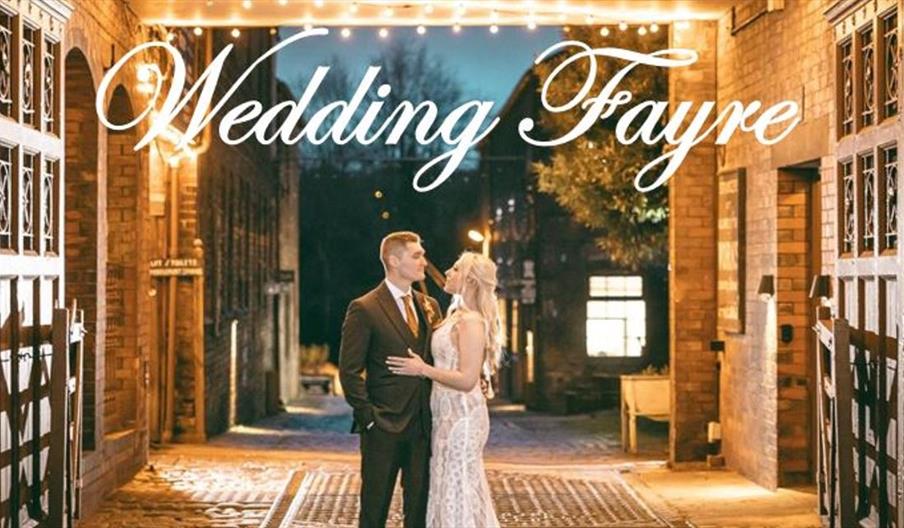 A newlywed couple stand in the beautifully-lit entrance way to Middleport Pottery for this promotional wedding fayre image