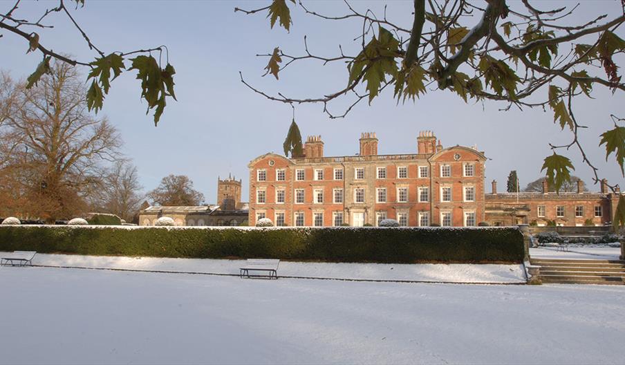 The house at Weston Park surrounded by snowy landscape