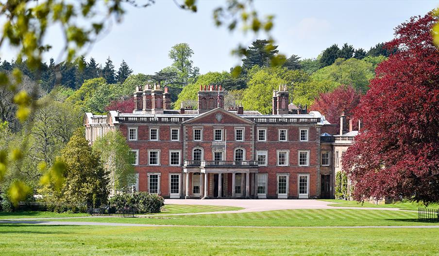 Image shows the House at Weston Park, seen from afar on a sunny day