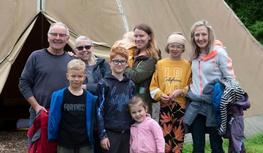 image of children in front of a tent