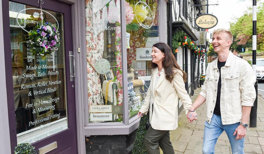image of a male and female walking along Cheadle High Street