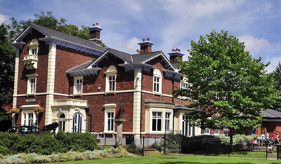 Photograph shows the exterior of the Brampton Museum on a sunny day