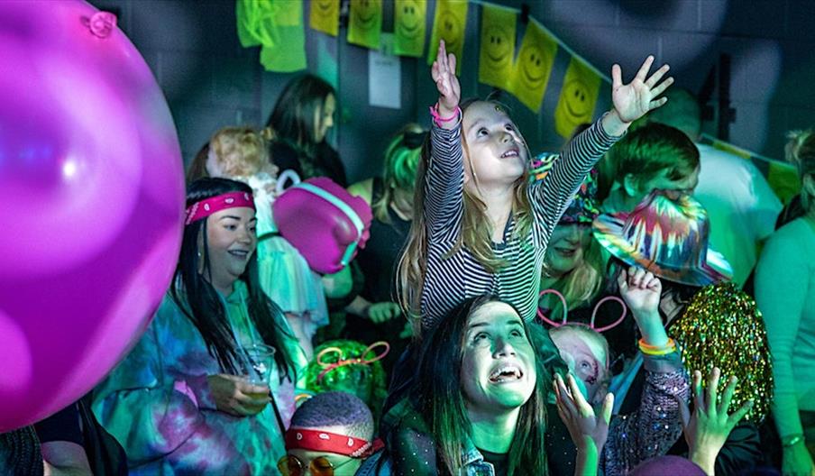 A girl on her mum's shoulders enjoys the show at the Big Fish Little Fish Family Rave, in Stafford, Staffordshire