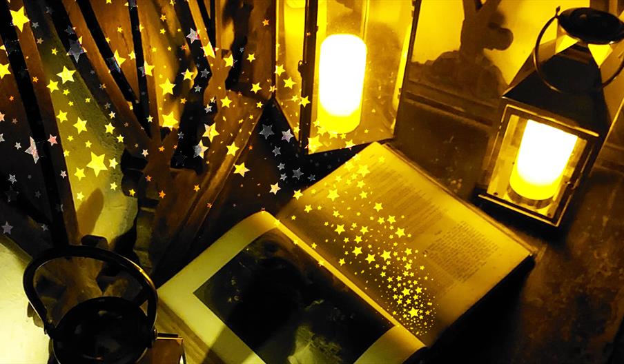 A picture of a magical book surrounded by lanterns