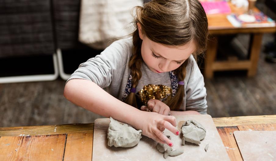 Girl modelling clay