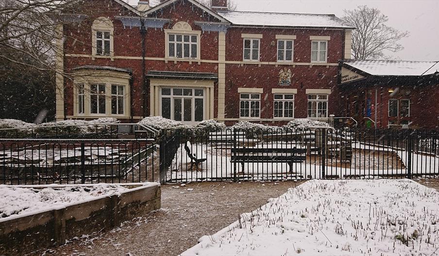 Photo shows the exterior of the Brampton museum on a snowy day