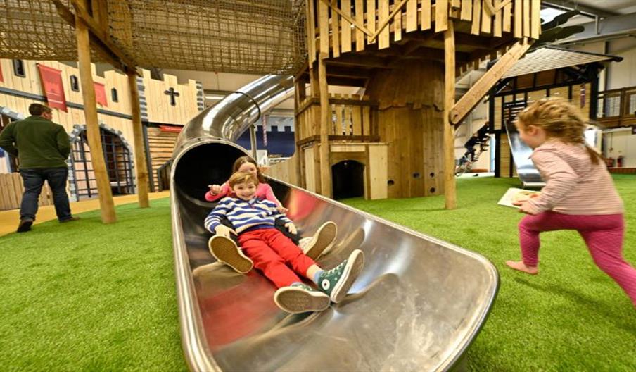 Kids on an indoor slide at Hockerhill Adventure Playbarn