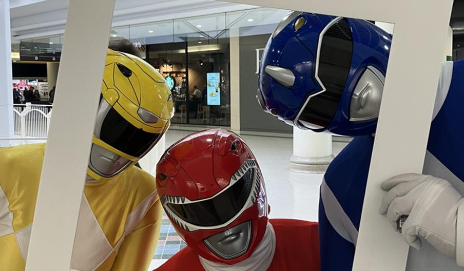 An image of some Power Rangers peering through a photo frame at The Potteries Centre, Stoke-on-Trent