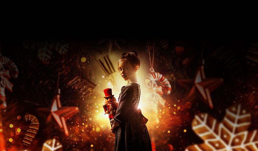 Young girl holding a nut cracker doll
