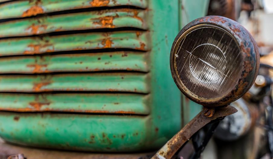 A close up of a vintage engine - maybe a tractor or truck