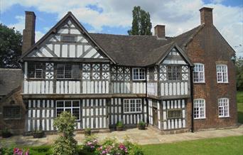 An image of an old Tudor building on a sunny day