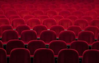 Empty red seats in a theatre