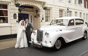 Classic Car with Bride and Groom outside the George Hotel.
