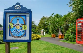 Biddulph Moor village green, with village sign and red telephone box