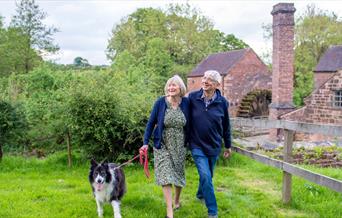 image of a couple walking past Cheddleton Flint Mill