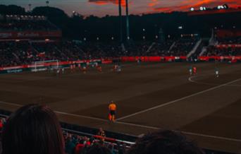 Football game at sunset in stadium
