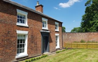 Photo shows the front of the Gardners Cottage on a sunny day
