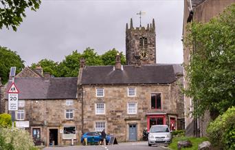 Longnor Village high street, shops fronts and the church in the background