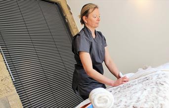 Getting the treatment couch ready at Peak Relaxation, Staffordshire