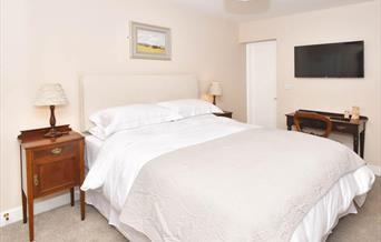 A view of Room 1 at The Royal Oak, showing the bed, furnishings, and plasma screen TV