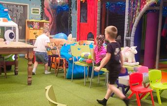 Children at play with interactive indoor soft play toys