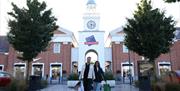 Two happy shoppers leave McArthurGlen West Midlands after a satisfying day of bargain hunting