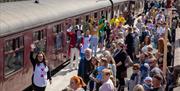 A busy day for the Mad Hatter's Tea Party at Churnet Valley Railway, with visitors welcomed by performers on the station platform