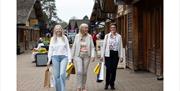Friends walking through the Trentham Shopping Village.