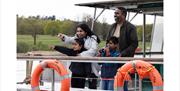 Family enjoying Trentham Lake Discovery Cruise.