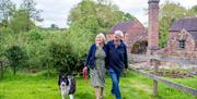 image of a couple walking past Cheddleton Flint Mill