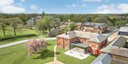 A drone shot of Constantine House and grounds, on a beautiful sunny day