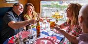 Two couples enjoy a curry aboard a steam train