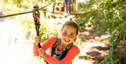 Girl on tree-to-tree crossing at Go Ape