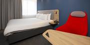 A view of one of the bedrooms, showing the comfortable double bed and the desk/chair area