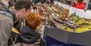 Father and son looking at model train