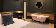 Double bedroom with roll top bath