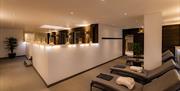 The Nordic Suite at Hoar Cross Hall, with a row of comfy-looking day beds and candles and low-level lighting to set the mood