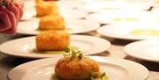 Image shows garnish being added to a meal at the Hammersley Restaurant, Stoke-on-Trent College