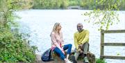 two people sitting on  rock beside Knypersley Pool