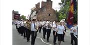 image of a Brass Band walking in the Leek Club Day Procession