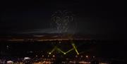 Space Safari drone light show with illuminated lion formation drones above a crowd at night