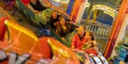 Young visitors on a fairground ride