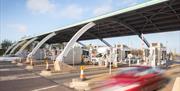 Vehicles pass through the booths on the M6 Toll Road in Staffordshire