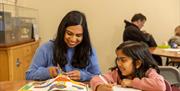 A mum and daughter enjoy some crafting