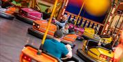 Visitors have a go on the dodgems at a fairground