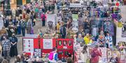 A hall full of stands selling wool and yarn.